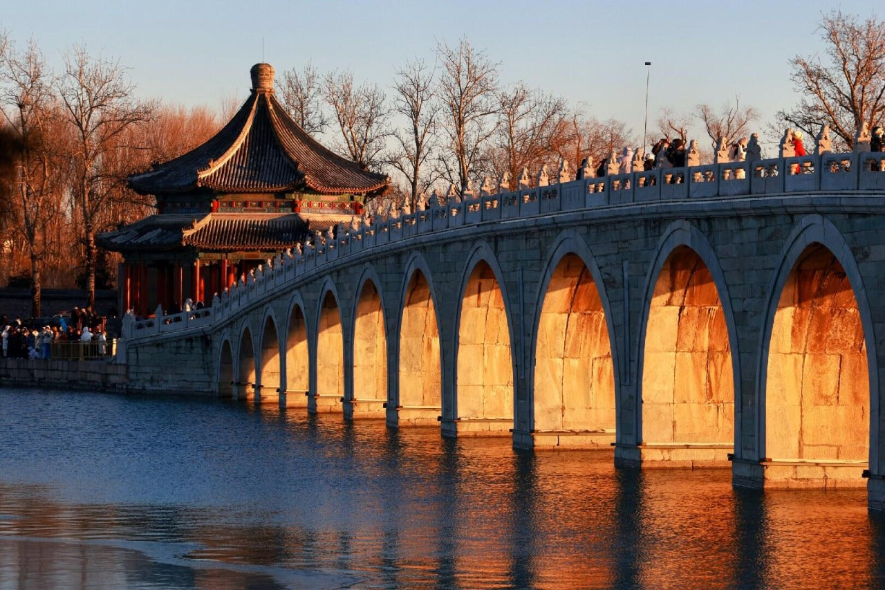 Ancient Chinese bridge and pavilion at sunset, part of 30-Day China Panoramic Deep Tour exploring 17 cities and iconic landmarks.