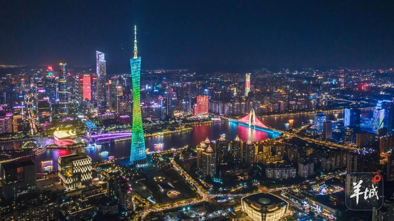 Aerial view of Guangzhou skyline at night with Canton Tower, vibrant city lights, and Pearl River; part of 30-day China panoramic tour.