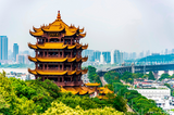Yellow Crane Tower in Wuhan, China, with city skyline and Yangtze River Bridge; part of 30-Day China Panoramic Deep Tour.