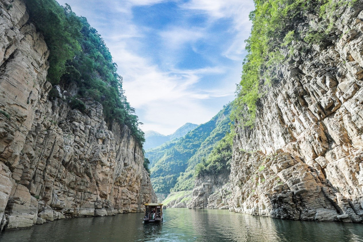 Scenic canyon view with boat tour, part of 30-Day China Panoramic Deep Tour exploring 17 cities and iconic landscapes.