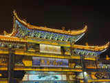 Illuminated traditional Chinese architecture at night, showcasing vibrant colors, perfect for the 30-Day China Panoramic Deep Tour.